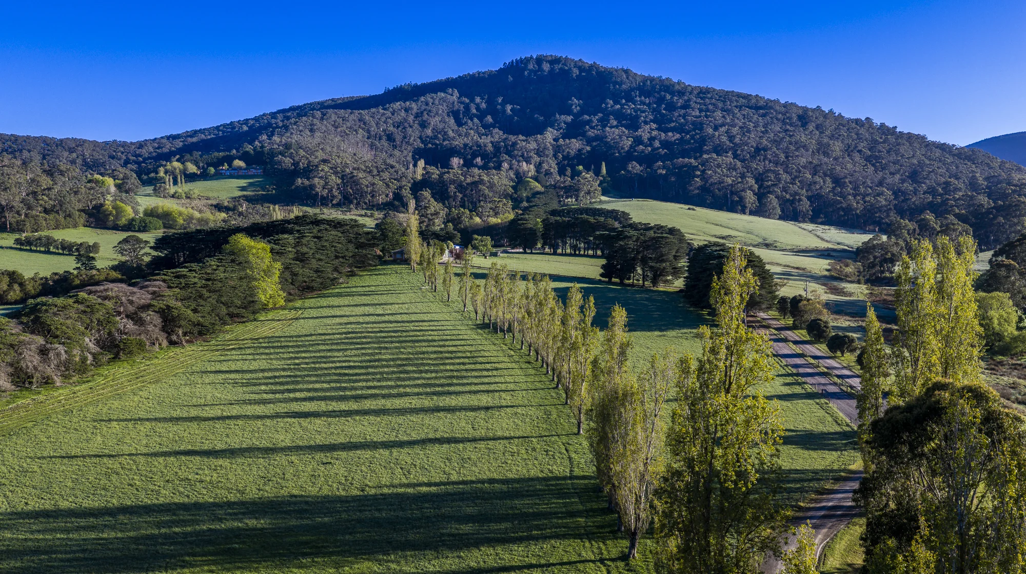 Aerial view of the estate pasture, dam and wooded hills